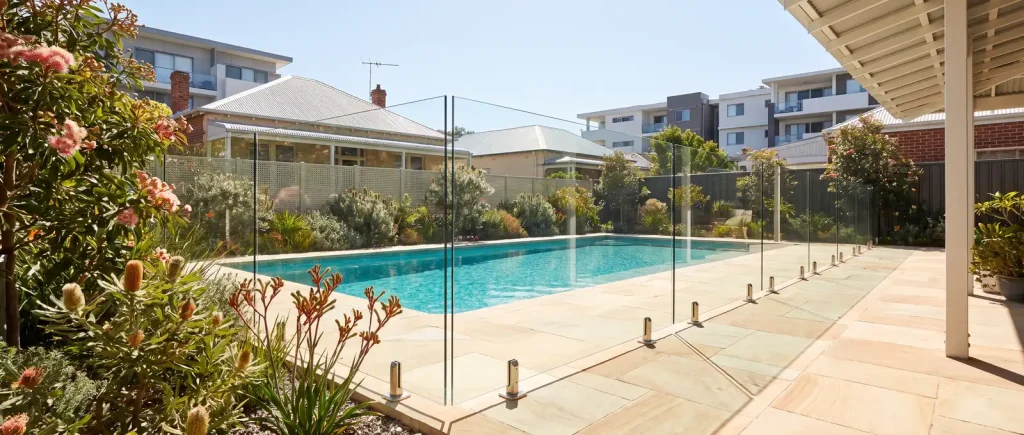 Frameless glass pool fencing framing a backyard pool oasis in Northbridge, WA