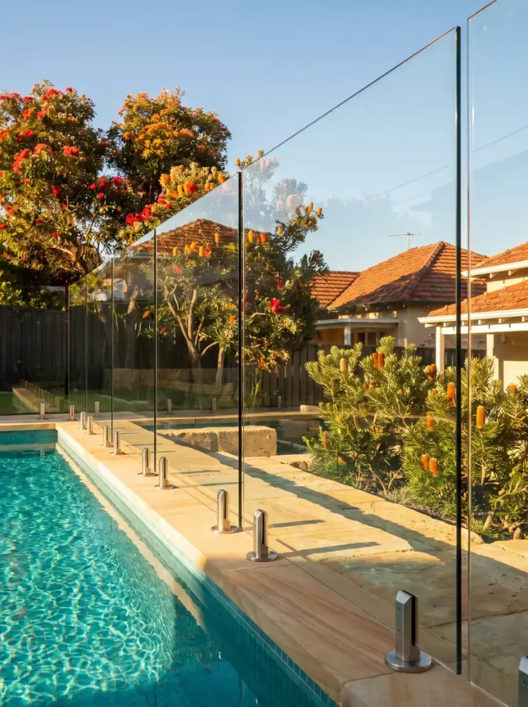 Frameless glass pool fencing around a turquoise pool in Northbridge, Perth backyard
