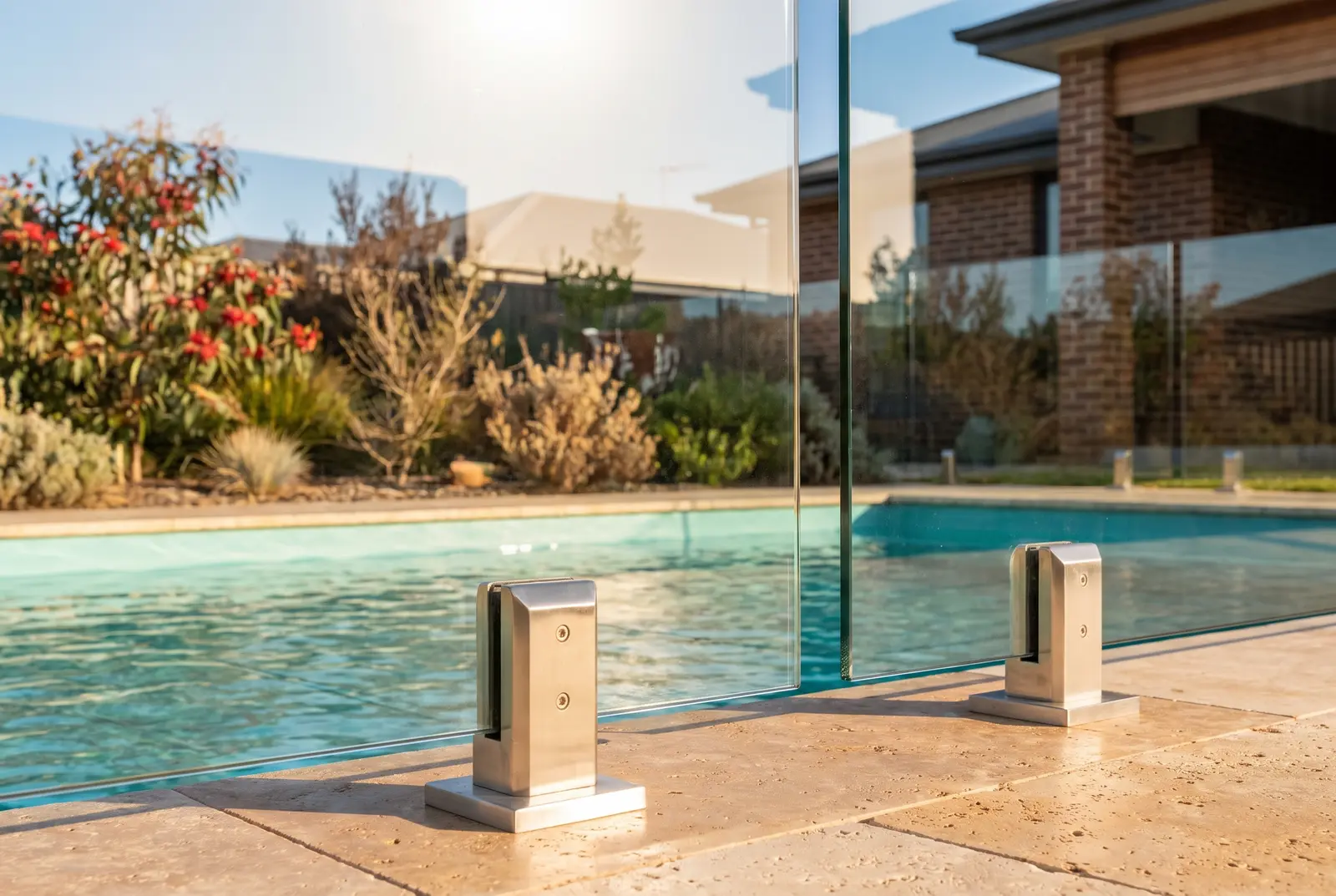 Frameless glass pool fencing with spotless polished panels beside a pool in Northbridge